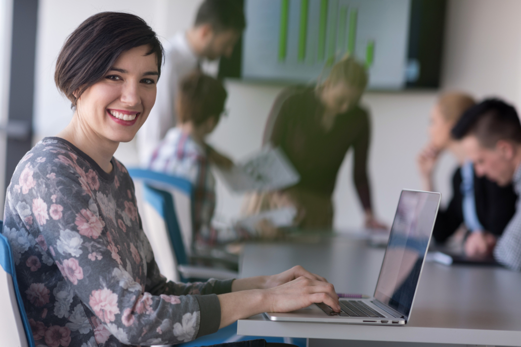 A young employee smiling confidently in a professional workplace. A young employee smiling confidently in a professional workplace.
