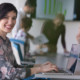 Hmrc tax updates for iab members A young employee smiling confidently in a professional workplace.