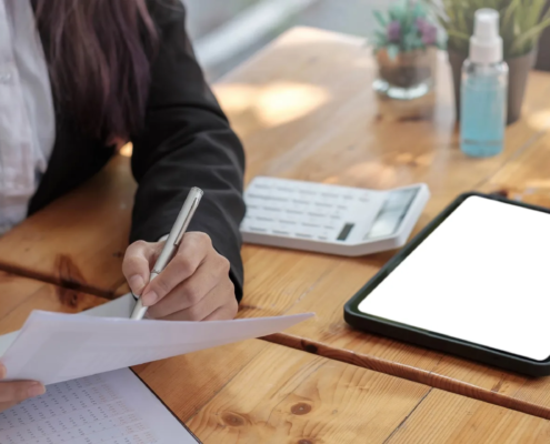 Professional reviewing documents with a tablet