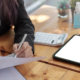 Christmas party tax Professional reviewing documents with a tablet