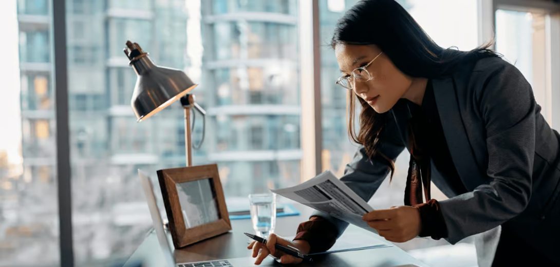 Finance professional working on a laptop in a modern office